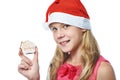 Happy teen girl in red cap with Christmas cookie isolated Royalty Free Stock Photo