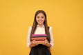 happy teen girl in school uniform hold book stack, reading