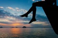 Happy teen girl sitting on beach at the dawn time Royalty Free Stock Photo