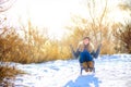 Happy teen girl sledding in the park at sunset Royalty Free Stock Photo