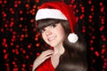 Happy teen girl smiling, santa wears in red hat with white fur p Royalty Free Stock Photo