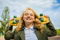 Smiling Teenage Girl With Skate Board Looking At Camera Sitting Outside Royalty Free Stock Photo