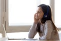 Happy teen girl wearing headphones listening to music podcast Royalty Free Stock Photo