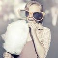 Happy teen girl in sunglasses eating cotton candy Royalty Free Stock Photo