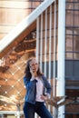 Teen girl having a mobile phone talk in a large metropolis Royalty Free Stock Photo