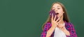 happy teen girl talking on mobile phone in high school at blackboard, voice email. Banner of school girl student Royalty Free Stock Photo