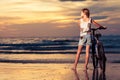 Happy teen girl walking on the beach at the sunset time Royalty Free Stock Photo
