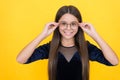 happy teen girl wearing glasses because of bad eyesight, oculist