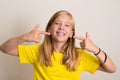 Happy teen girl in yellow t-shirt showing her dental brace.