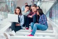 Happy teen girls and boys on the stairs school or college Royalty Free Stock Photo