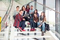 Happy teen girls and boys on the stairs school or college Royalty Free Stock Photo