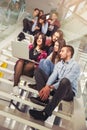 Happy teen girls and boys on the stairs school or college. Royalty Free Stock Photo