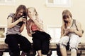 Happy teen girls calling on the cell phones Royalty Free Stock Photo