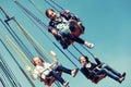 Happy teen girls on the chain swing carousel