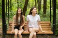 Happy teen girls swing on a swing in the summer in the park, young women laughing,girls on weekends