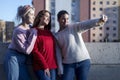 Happy teen girls taking selfie in park with mobile phone outdoors Royalty Free Stock Photo