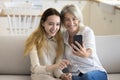 Happy teen grandkid and pretty blonde grandmother taking self picture Royalty Free Stock Photo