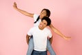 Happy teen guy giving piggyback ride to his girlfriend Royalty Free Stock Photo