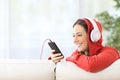 Happy teen listening music from phone