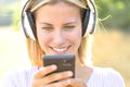 Happy teen listening to music watching phone content Royalty Free Stock Photo