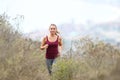 Happy teen running in the mountain alone