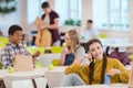 happy teen schoolgirl talking by phone