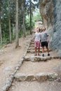 Happy teen son and senior father looking up in forest.