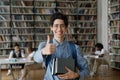 Happy teen student in eye glasses and backpack holding books Royalty Free Stock Photo