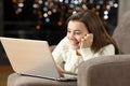 Teen using a laptop at home in the night