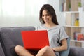 Teen using a computer sitting on a couch