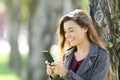 Happy teen using a smart phone outdoors Royalty Free Stock Photo