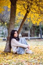 Happy teen woman listening to music and relax in autumn park. Yellow trees, beautiful fall time Royalty Free Stock Photo