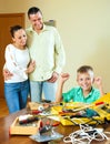 Happy teenag making something with working tools, parents are wa Royalty Free Stock Photo