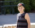 A Happy Teenage Boy in a Cap Smiles for a Portrait