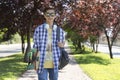 Happy teenage boy caucasian student going to high school. Outdoor portrait. Secondary education Royalty Free Stock Photo