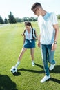 happy teenage boy and girl playing with soccer ball Royalty Free Stock Photo