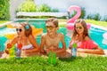 Teens drinking cocktails relaxing in swimming pool Royalty Free Stock Photo