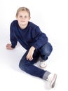 Happy teenage boy sitting on the floor Royalty Free Stock Photo