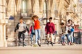 Happy teenage boys and girls rollerblading in city Royalty Free Stock Photo