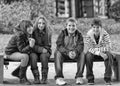 Happy teenage boys and girls sitting having fun in spring park Royalty Free Stock Photo