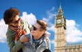 Happy teenage couple having fun over big ben tower Royalty Free Stock Photo