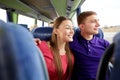 Happy teenage couple or passengers in travel bus Royalty Free Stock Photo