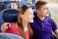 Happy teenage couple or passengers in travel bus Royalty Free Stock Photo