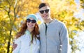 Happy teenage couple walking in autumn park Royalty Free Stock Photo