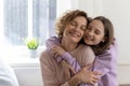 Happy teenage daughter hug mom showing love and care Royalty Free Stock Photo