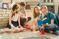 Happy 4 teenage friends or high school students reading books. Friendship and people concept Royalty Free Stock Photo