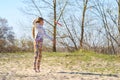 Happy teenage girl, blonde catches flying disk in a jump Royalty Free Stock Photo