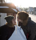 Happy teenage girl and boy, about 16-17 years old, lick a large icicle with their tongues Royalty Free Stock Photo