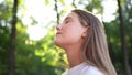 happy teenage girl closed her dream eyes in the park. teenager wants a dream portrait at sunset forest. woman daughter Royalty Free Stock Photo