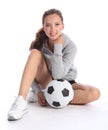 Happy teenage girl football player sits with ball Royalty Free Stock Photo
